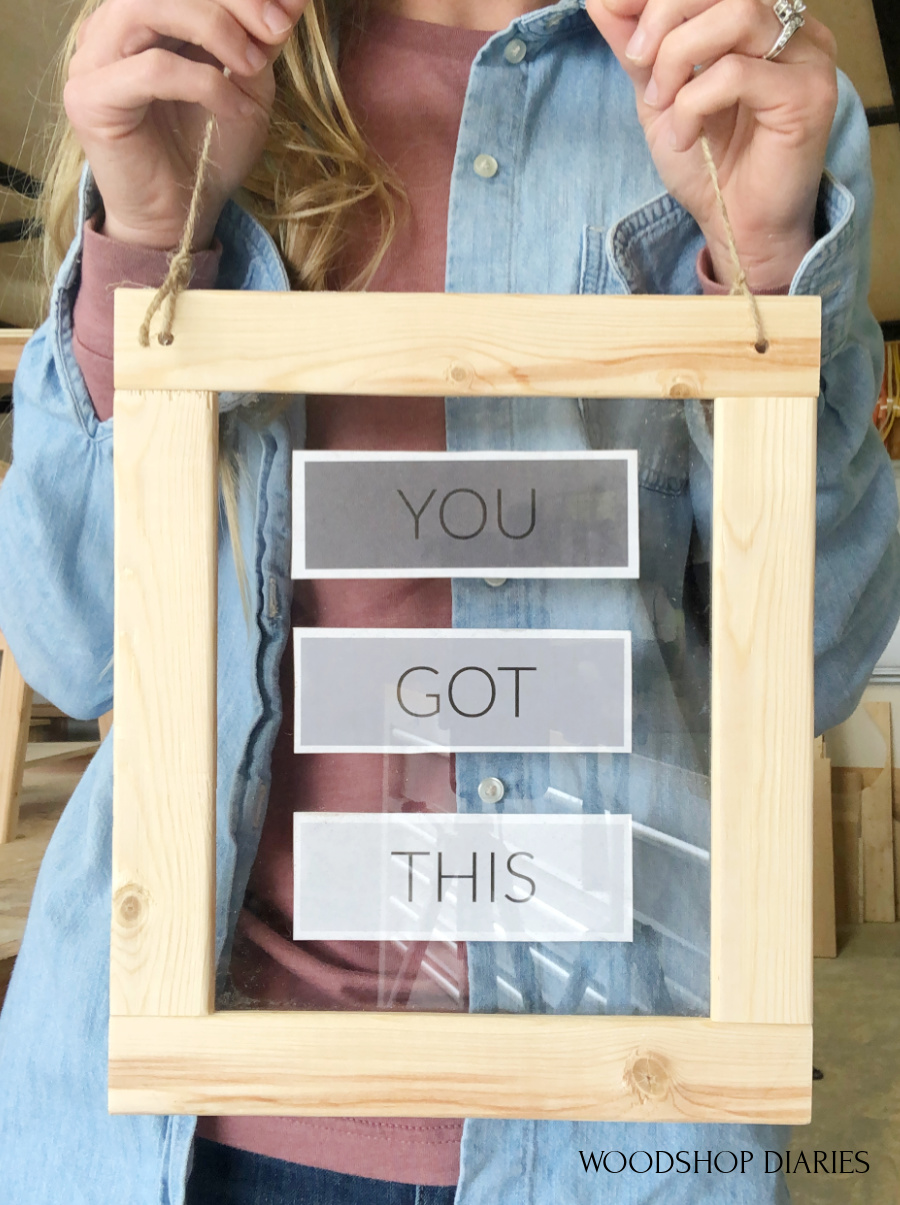 https://www.woodshopdiaries.com/wp-content/uploads/2021/05/Shara-Woodshop-Diaries-holding-easy-picture-frame.jpg