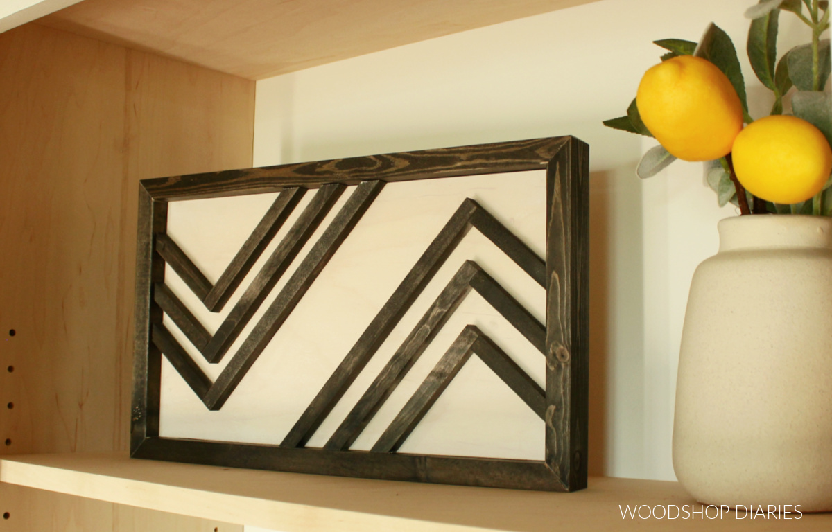 Black and white wood wall decor with shelf